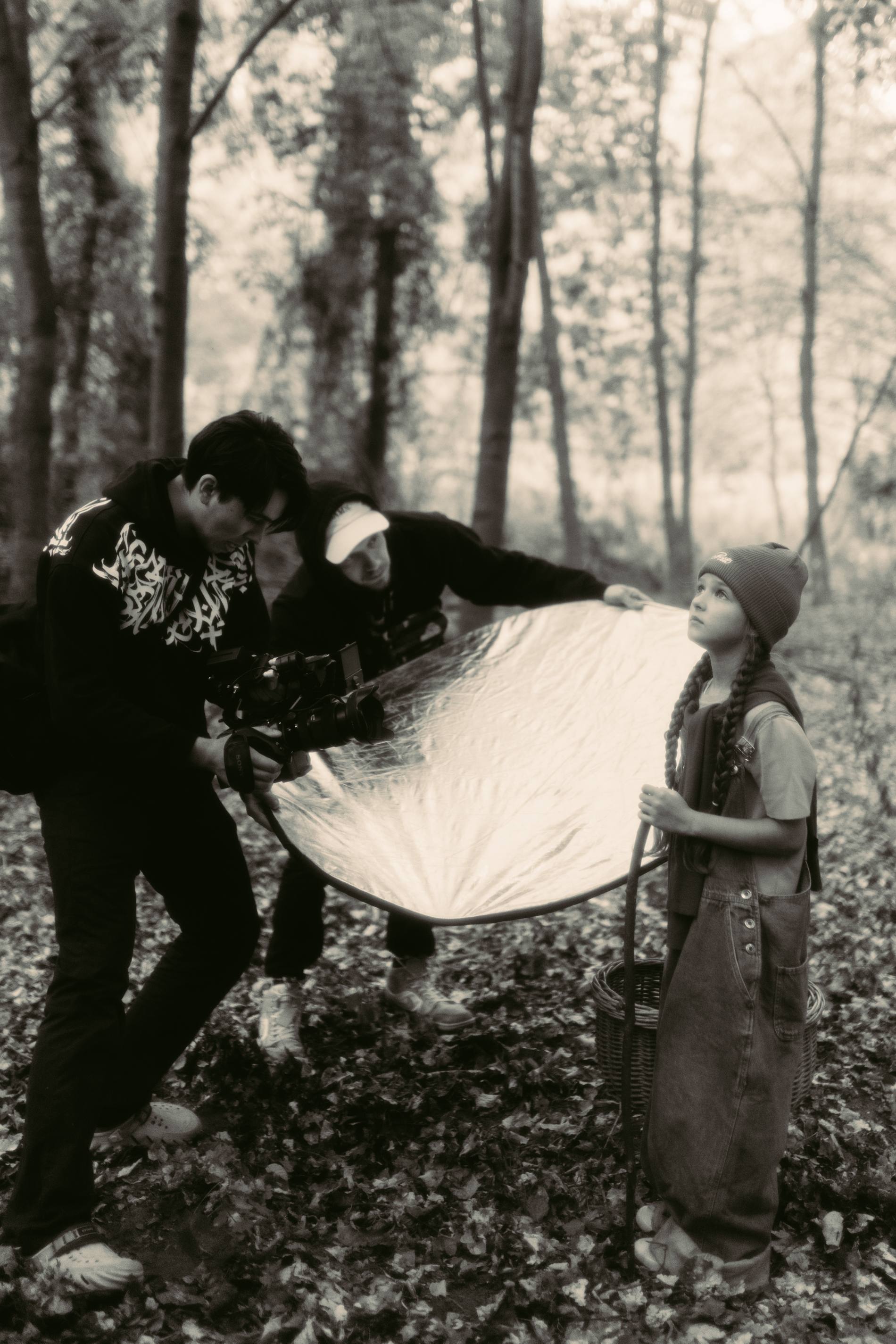 On set in the forest — bouncing light onto a young actor