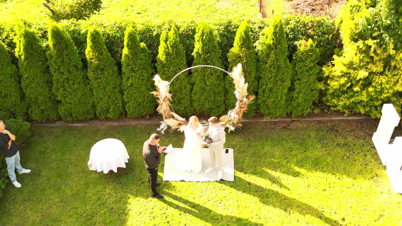 Aerial over a garden wedding ceremony